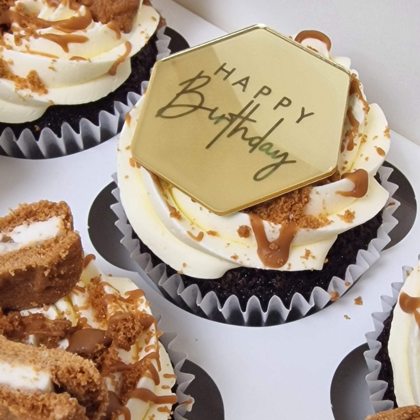 Biscoff cupcakes with vanilla and chocolate base topped with Biscoff spread and biscuit pieces for delivery in Basildon Essex
