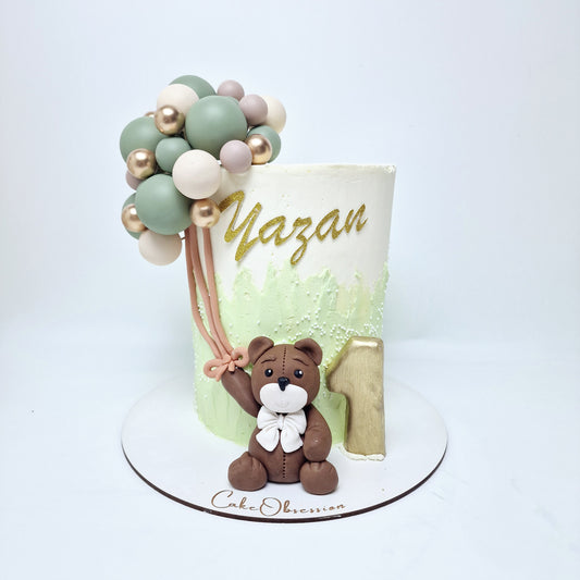 This delightful teddy bear cake is a sweet centerpiece for any celebration. Featuring a charming handmade teddy bear crafted with care, it sits proudly at the front of the cake, holding a colorful bunch of balloons that add a playful touch. The cake can be customized to make it truly personal—simply fill in the form above with the name of your choice, and it will be lovingly added to the design. Perfect for birthdays, baby showers, or any special occasion, this cake is as heartwarming as it is delicious.