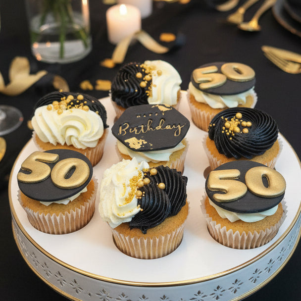 Black and gold 50th birthday cupcakes with personalised toppers, black buttercream swirls and edible gold decorations – luxury birthday cupcakes delivery in Basildon Essex