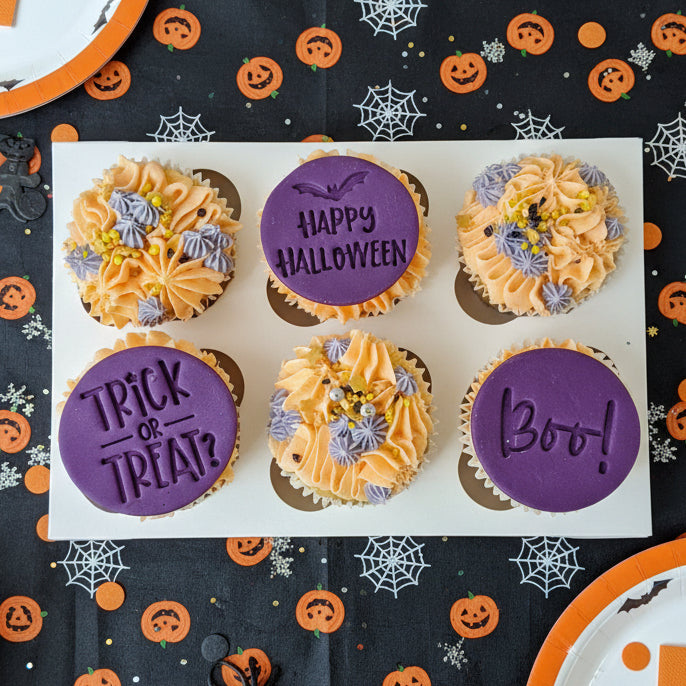 Halloween cupcakes with purple toppers saying Trick or Treat, Happy Halloween, and Boo for delivery in Basildon Essex