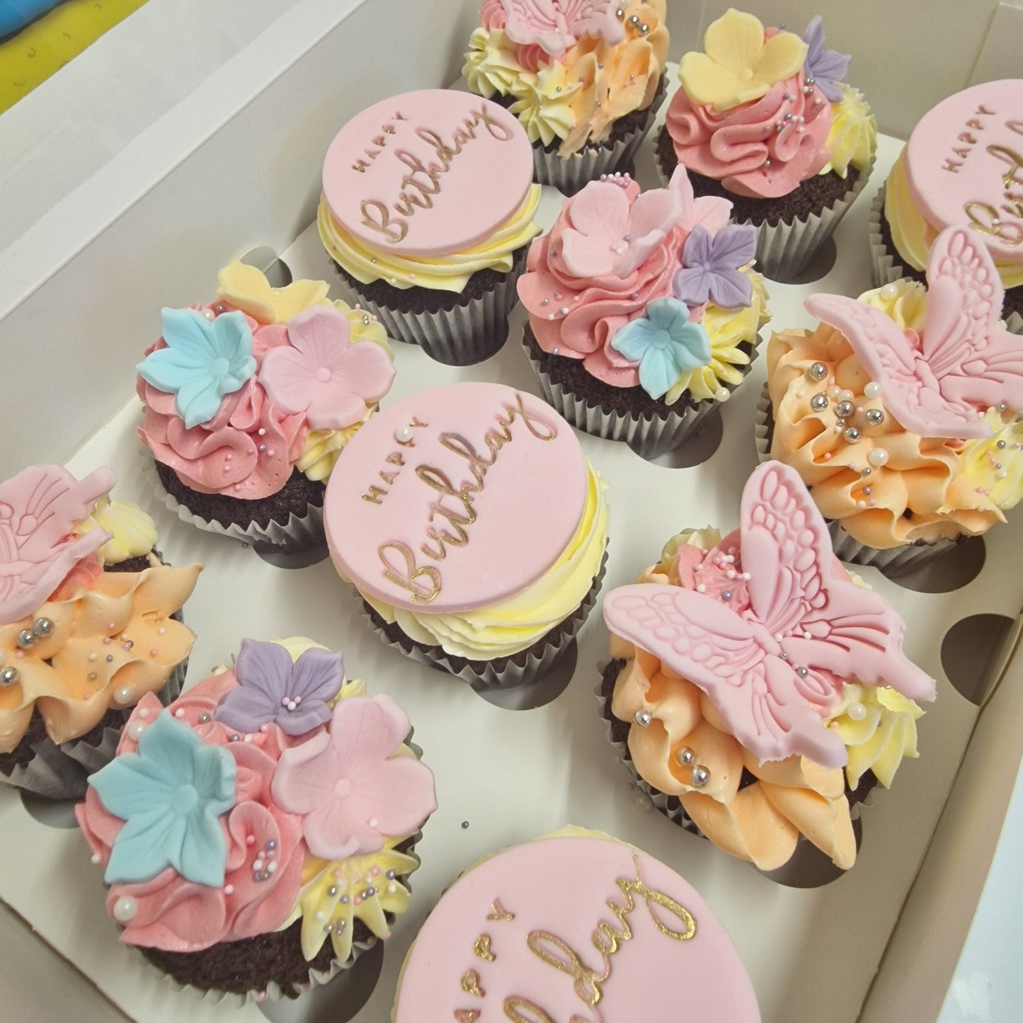 Floral and butterfly cupcakes with handcrafted sugarpaste decorations for delivery in Basildon Essex