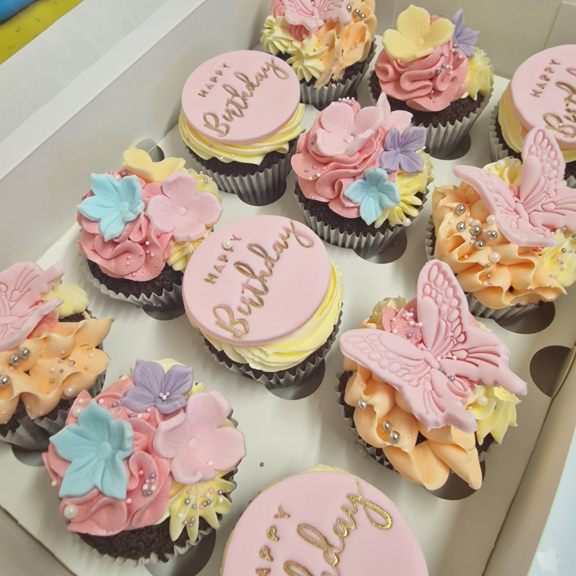 Floral and butterfly cupcakes with handcrafted sugarpaste decorations for delivery in Basildon Essex