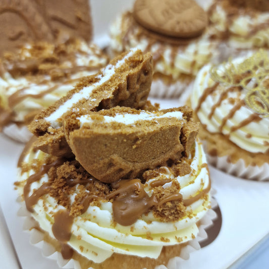 Close-up of biscoff cupcakes, featuring fluffy cupcakes topped with creamy buttercream, a drizzle of biscoff spread, and a lotus biscoff cookie garnish."
