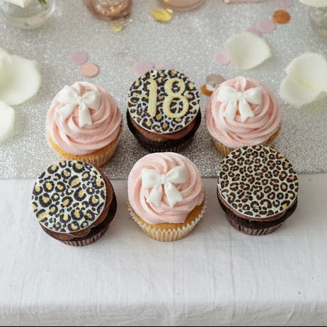 Cheetah print and pink birthday cupcakes with bow topper for delivery in Basildon Essex