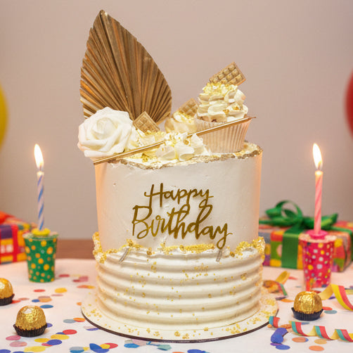 Elegant Gold Celebration Cake with white buttercream, golden sprinkles, golden fan, cupcake topper, and tall candle, handmade and personalised, perfect for birthdays and special occasions, available for delivery in Basildon and Essex.