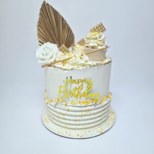 Add a touch of sophistication to your celebration with our elegant birthday cake! This stunning white cake is adorned with golden sprinkles, a chic golden fan, and crowned with a beautifully decorated cupcake on top. A tall, elegant candle adds a touch of grandeur, making it the perfect centerpiece for birthdays or special occasions. 