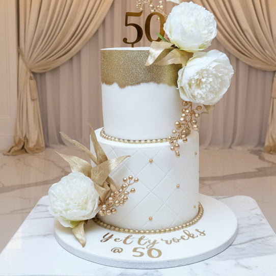 Two-tier white and gold elegant cake made in Basildon Essex for weddings and special occasions