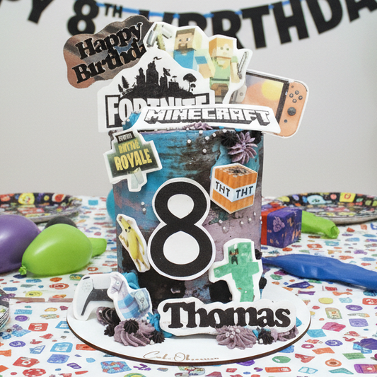 Cake with 'Happy Birthday' and 'Minecraft' design, featuring various gaming elements on a white background.