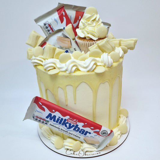 Treat yourself to this stunning cake, decorated with a smooth white chocolate drip, buttercream swirls, and topped with Milky Bar chocolates. Perfect for birthdays and special occasions.