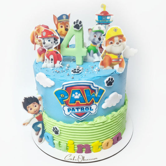 Paw Patrol birthday cake with cartoon characters and colorful design on a white background