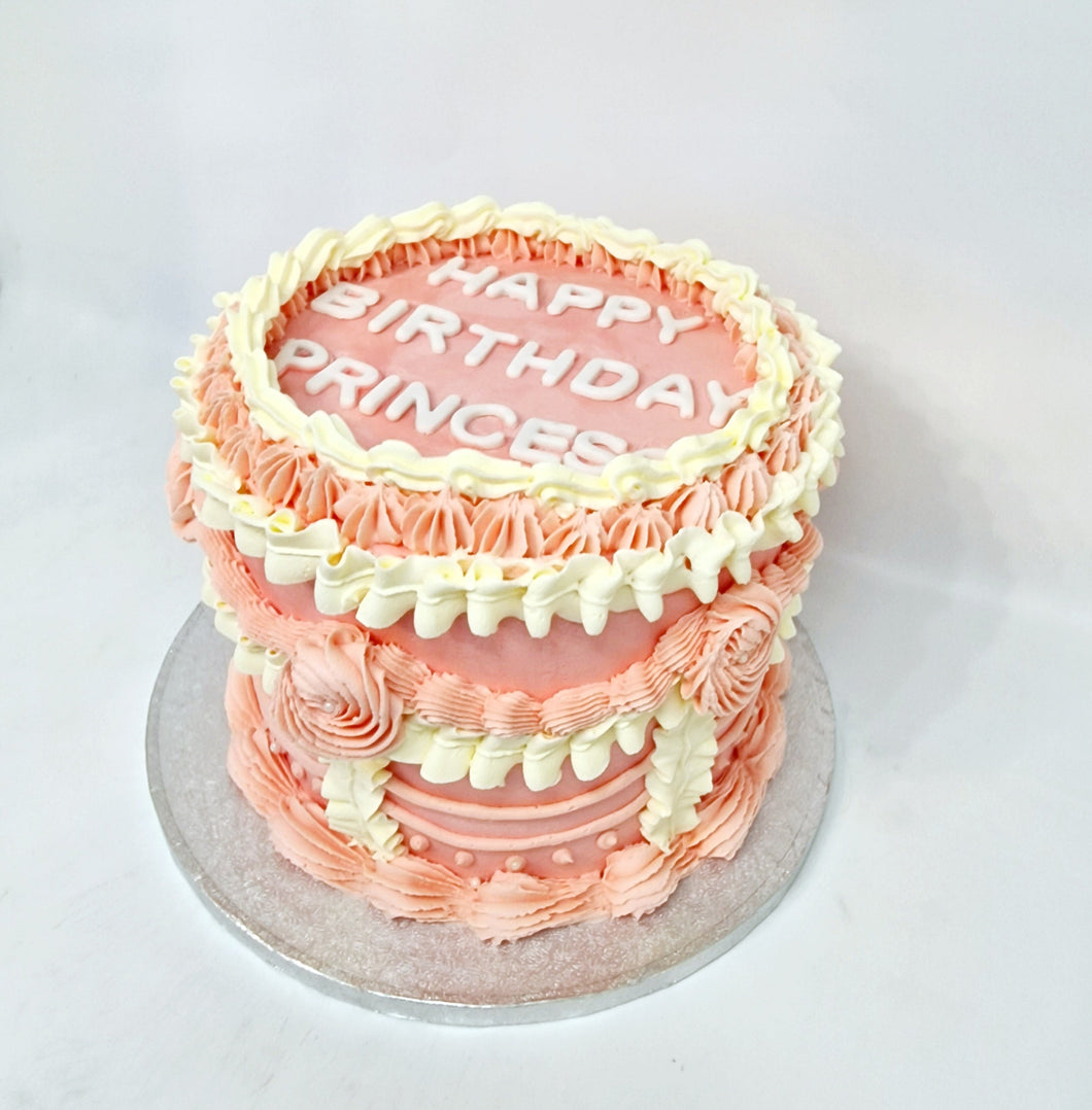 This elegant cake, adorned with delicate pink and white piping, is the perfect choice for a sophisticated birthdayVintage Cake
