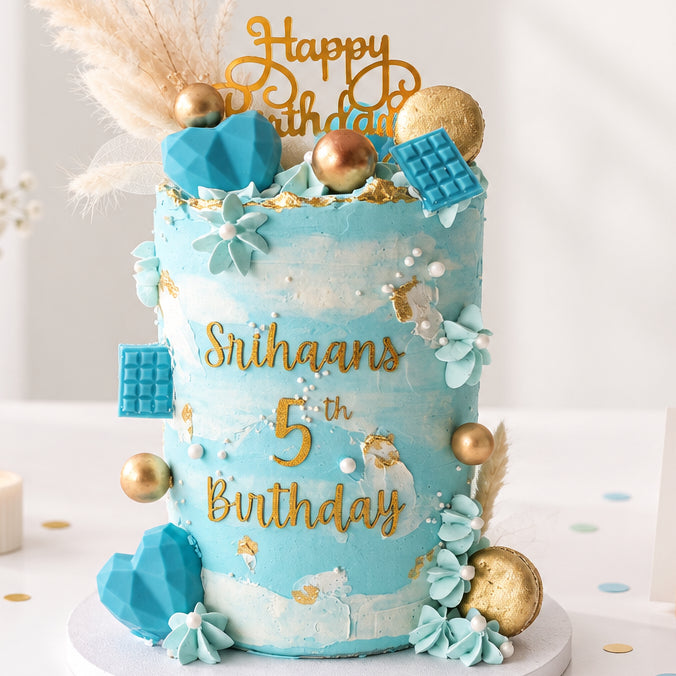 Personalised blue and gold birthday cake with name and age decoration, available for delivery across Essex from CakeObsession.