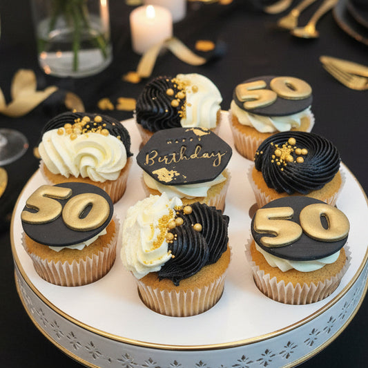 Black and gold 50th birthday cupcakes with personalised toppers, black buttercream swirls and edible gold decorations – luxury birthday cupcakes delivery in Basildon Essex