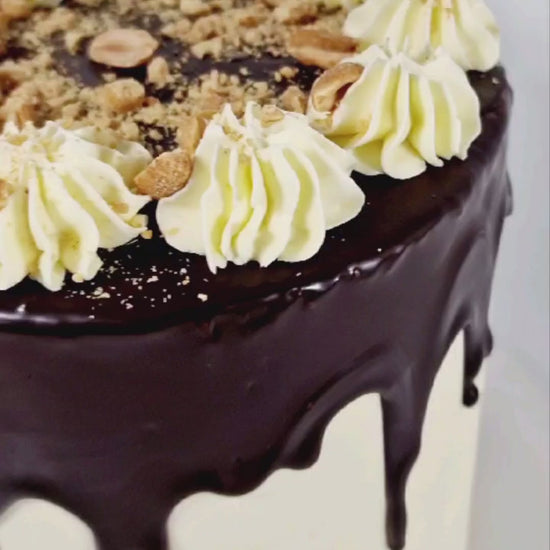 Peanut Butter Drip Celebration Cake with peanut butter sponge, chocolate drip, buttercream swirls, and peanut crumbs, handmade and personalised, perfect for birthdays and special occasions, available for delivery in Basildon and Essex.